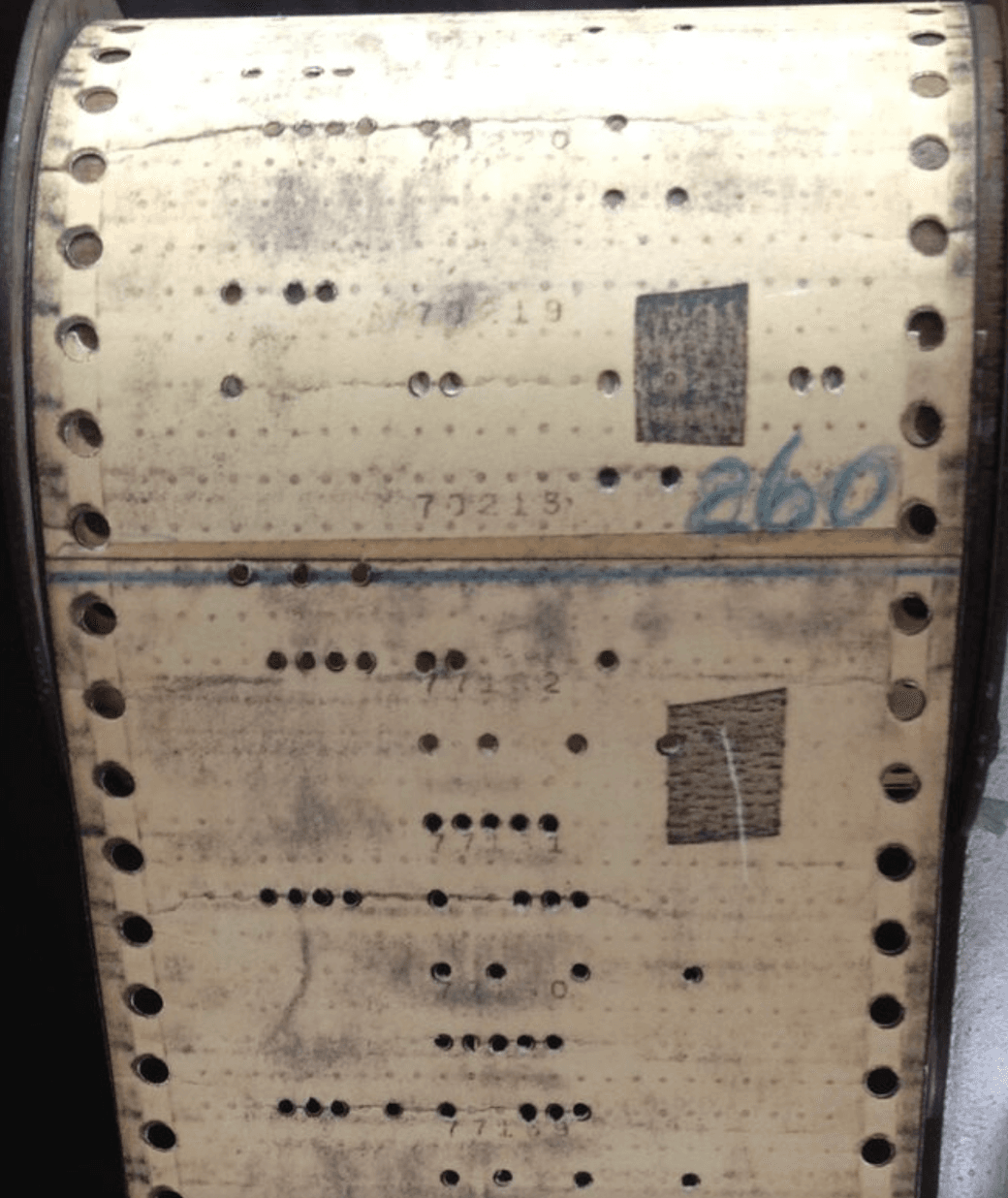 Photo of a punch car with two pieces of tape over holes