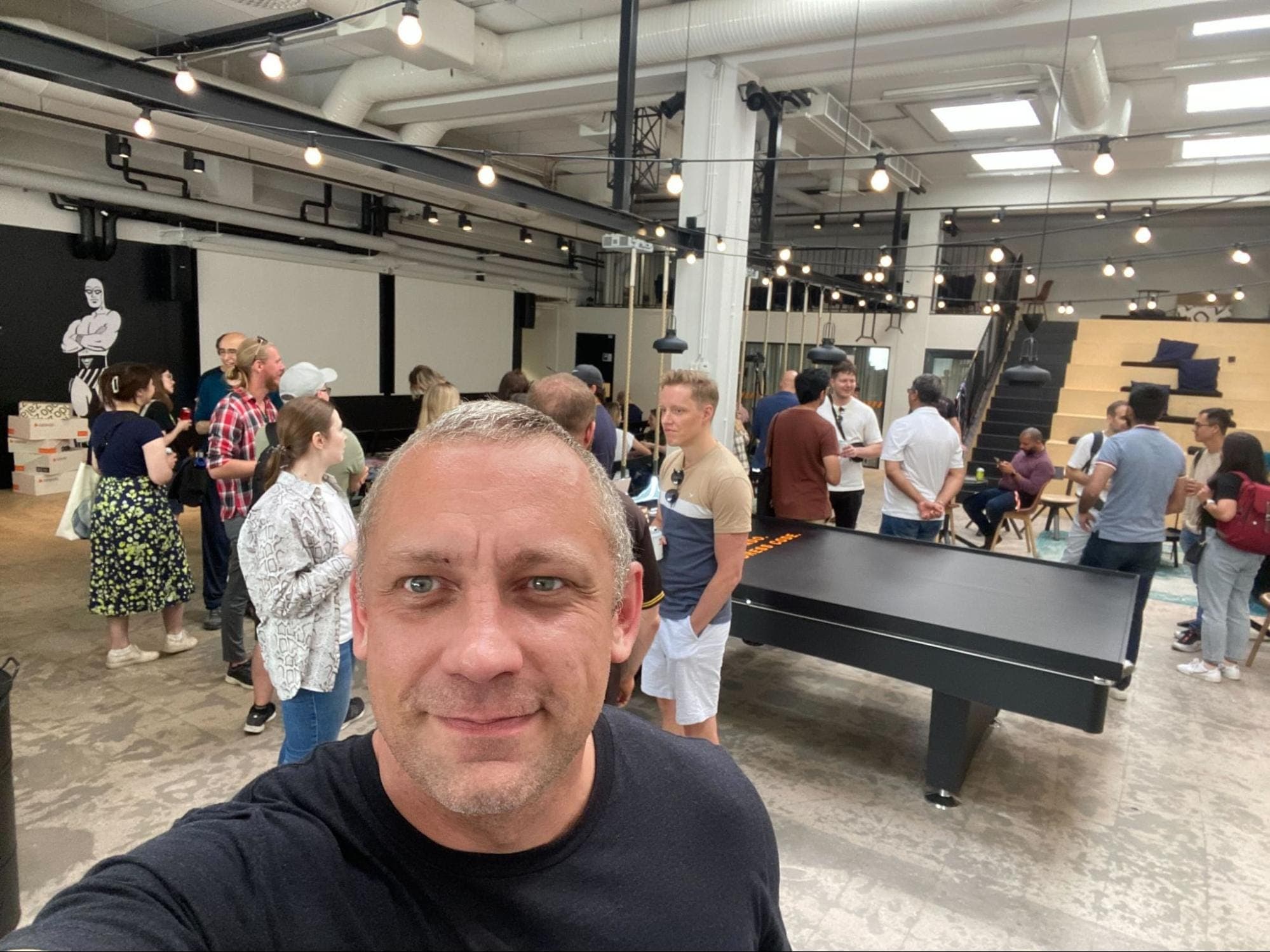 Selfie of Vitaly Sharovatov in front of a crowd at Zalando/Qase Quality Engineering meetup in Helsinki