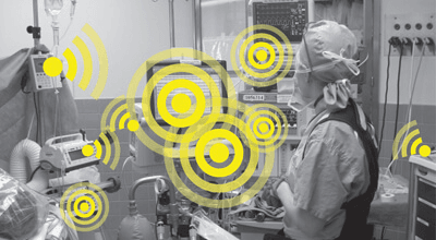 Photo of doctor near several machines, icons indicate several machines making noise at once